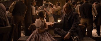 Movie still from “A Million Ways to Die in the West” (2014), directed by Seth MacFarlane – A man and a little girl are sitting in a room; Medium shot, Over the shoulder angle