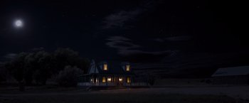 Movie still from “A Million Ways to Die in the West” (2014), directed by Seth MacFarlane – A house with a porch lit up at night; Extreme Wide shot, Low angle