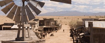 Movie still from “A Million Ways to Die in the West” (2014), directed by Seth MacFarlane – A group of people standing on top of a dirt field; Extreme Wide shot, High angle