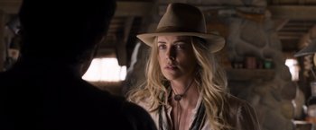 Movie still from “A Million Ways to Die in the West” (2014), directed by Seth MacFarlane – A woman wearing a brown hat and a necklace; Close Up shot, Over the shoulder angle