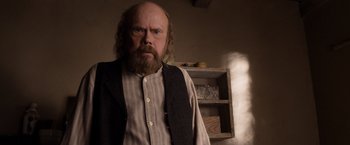 Movie still from “A Million Ways to Die in the West” (2014), directed by Seth MacFarlane – An old man with a beard and a mustache; Medium shot, Over the shoulder angle