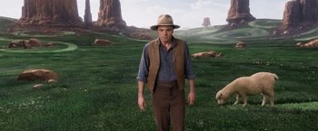 Movie still from “A Million Ways to Die in the West” (2014), directed by Seth MacFarlane – A man standing in the middle of a field with sheep; Medium shot, Low angle