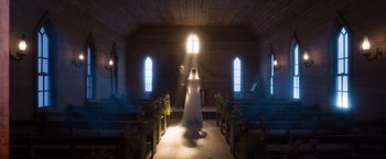Movie still from “A Million Ways to Die in the West” (2014), directed by Seth MacFarlane – A man and woman standing inside a church; Wide shot, Low angle