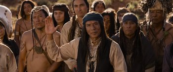 Movie still from “A Million Ways to Die in the West” (2014), directed by Seth MacFarlane – A group of native american men standing in a row; Medium shot, Over the shoulder angle