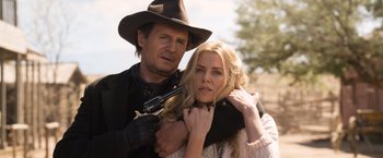 Movie still from “A Million Ways to Die in the West” (2014), directed by Seth MacFarlane – A man and a woman are holding a gun; Close Up shot, Over the shoulder angle