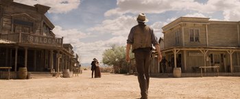 Movie still from “A Million Ways to Die in the West” (2014), directed by Seth MacFarlane – A man and a woman are walking down a dirt road; Wide shot, Low angle