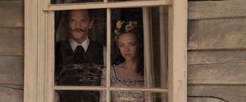 Movie still from “A Million Ways to Die in the West” (2014), directed by Seth MacFarlane – A man and a woman looking out of a window; Medium shot, Over the shoulder angle