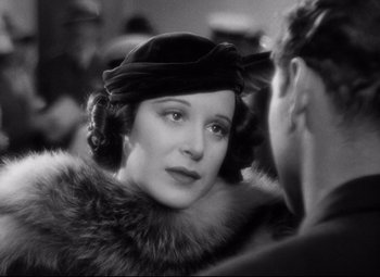 Movie still from “A Night at the Opera” (1935), directed by Sam Wood – An old photo of a woman wearing a hat and fur; Close Up shot, Over the shoulder angle