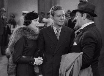 Movie still from “A Night at the Opera” (1935), directed by Sam Wood – Two men and a woman are talking to each other; Medium shot, Over the shoulder angle