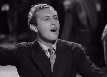 A black and white photo of a man singing