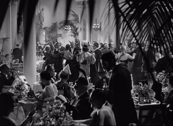Movie still from “A Night at the Opera” (1935), directed by Sam Wood – A black and white photo of people at a party; Wide shot, High angle