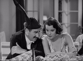 Movie still from “A Night at the Opera” (1935), directed by Sam Wood – A man and a woman sitting next to each other; Close Up shot, High angle