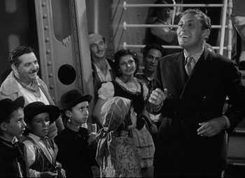 Movie still from “A Night at the Opera” (1935), directed by Sam Wood – A group of people standing next to each other on a boat; Medium shot, Over the shoulder angle
