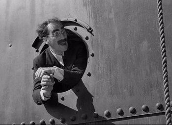 Movie still from “A Night at the Opera” (1935), directed by Sam Wood – A black and white photo of a man with a mustache; Medium shot, Low angle