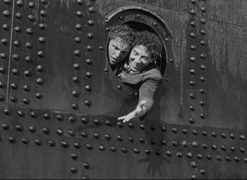 Movie still from “A Night at the Opera” (1935), directed by Sam Wood – Two people are looking out of a window; Medium shot, High angle