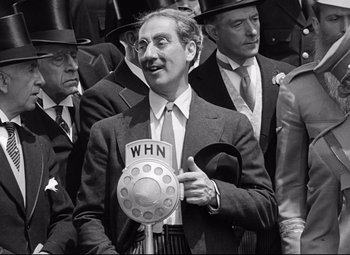 Movie still from “A Night at the Opera” (1935), directed by Sam Wood – An old photo of a man in a suit and tie; Close Up shot, Low angle