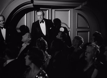 Movie still from “A Night at the Opera” (1935), directed by Sam Wood – A black and white photo of a man in a tuxedo; Medium shot, Low angle