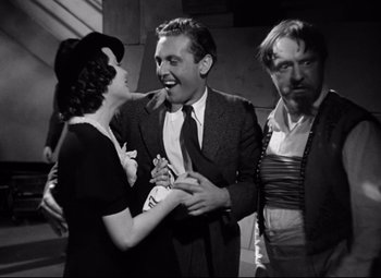 Movie still from “A Night at the Opera” (1935), directed by Sam Wood – A man and two women standing next to each other; Medium shot, Over the shoulder angle