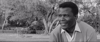 A black and white photo of a man in a park