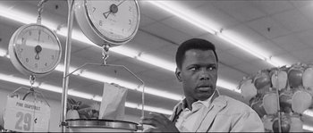 A black and white photo of a man in a grocery store