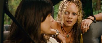 Movie still from “A Perfect Getaway” (2009), directed by David Twohy – Two women are talking to each other outside; Close Up shot, Over the shoulder angle