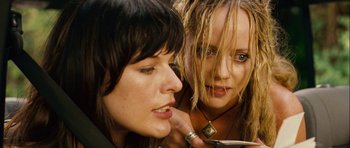 Movie still from “A Perfect Getaway” (2009), directed by David Twohy – Two women looking in the same direction in the mirror; Close Up shot, High angle