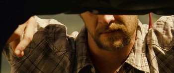 Movie still from “A Perfect Getaway” (2009), directed by David Twohy – A man with a beard and mustache; Extreme Close Up shot, Over the shoulder angle