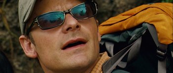 Movie still from “A Perfect Getaway” (2009), directed by David Twohy – A person wearing sunglasses and holding a pair of scissors; Close Up shot, Overhead angle
