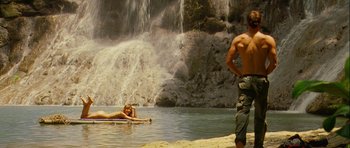 Movie still from “A Perfect Getaway” (2009), directed by David Twohy – A man and a woman are swimming in the water near a body of water; Wide shot, Low angle