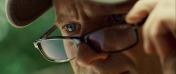 Movie still from “A Perfect Getaway” (2009), directed by David Twohy – A man's face with glasses; Extreme Close Up shot, Low angle