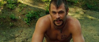 Movie still from “A Perfect Getaway” (2009), directed by David Twohy – A man with a tattoo on his chest; Close Up shot, Over the shoulder angle