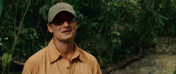 Movie still from “A Perfect Getaway” (2009), directed by David Twohy – A person wearing glasses and a hat; Close Up shot, Over the shoulder angle