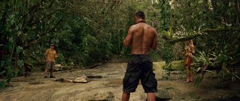 Movie still from “A Perfect Getaway” (2009), directed by David Twohy – A man standing in the middle of a river; Wide shot, Low angle