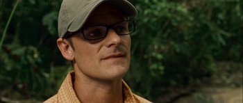 Movie still from “A Perfect Getaway” (2009), directed by David Twohy – A person wearing glasses and a hat; Close Up shot, Over the shoulder angle