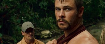 Movie still from “A Perfect Getaway” (2009), directed by David Twohy – A man with a beard is tying a neck tie; Close Up shot, Over the shoulder angle