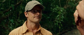 Movie still from “A Perfect Getaway” (2009), directed by David Twohy – A person wearing glasses and a hat; Close Up shot, Over the shoulder angle