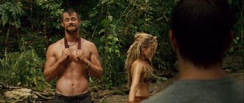 Movie still from “A Perfect Getaway” (2009), directed by David Twohy – A man and a woman in bikinis in the woods; Medium shot, Over the shoulder angle