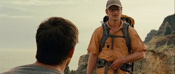 Movie still from “A Perfect Getaway” (2009), directed by David Twohy – A man with a backpack standing next to another man on top of a hill; Medium shot, Over the shoulder angle