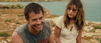 Movie still from “A Perfect Getaway” (2009), directed by David Twohy – A man and a woman sitting next to each other on a cliff; Close Up shot, Over the shoulder angle