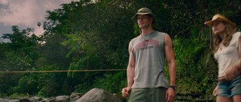 Movie still from “A Perfect Getaway” (2009), directed by David Twohy – A man standing in front of some trees; Medium shot, Low angle