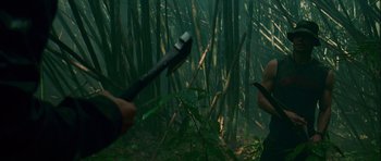 Movie still from “A Perfect Getaway” (2009), directed by David Twohy – Two people in the woods with a knife in their mouth; Medium shot, Low angle