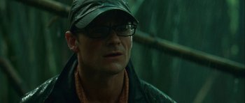 Movie still from “A Perfect Getaway” (2009), directed by David Twohy – A person wearing glasses and a hat; Close Up shot, Over the shoulder angle