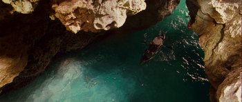 Movie still from “A Perfect Getaway” (2009), directed by David Twohy – A person in a canoe in the middle of the ocean; Extreme Wide shot, Overhead angle