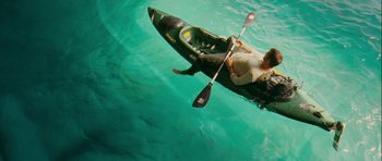 Movie still from “A Perfect Getaway” (2009), directed by David Twohy – A man is in a kayak in the water; Wide shot, Overhead angle