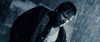 Movie still from “A Perfect Getaway” (2009), directed by David Twohy – A person wearing a jacket in the rain; Close Up shot, Low angle