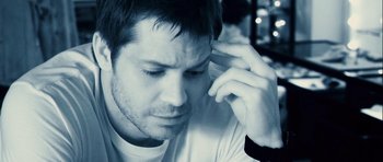 Movie still from “A Perfect Getaway” (2009), directed by David Twohy – A person holding a cell phone to his ear; Close Up shot, High angle