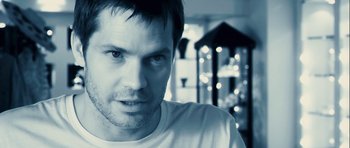 Movie still from “A Perfect Getaway” (2009), directed by David Twohy – A person wearing a white t - shirt; Close Up shot, Low angle