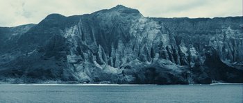 Movie still from “A Perfect Getaway” (2009), directed by David Twohy – A large body of water near a large mountain range; Extreme Wide shot, High angle