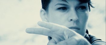 Movie still from “A Perfect Getaway” (2009), directed by David Twohy – A person with their hand up to their face; Extreme Close Up shot, Low angle