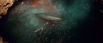 Movie still from “A Perfect Getaway” (2009), directed by David Twohy – A boat floating on top of a body of water; Extreme Wide shot, Overhead angle